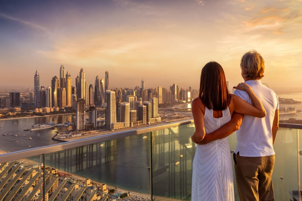 A couple looking out over Dubai at sunset