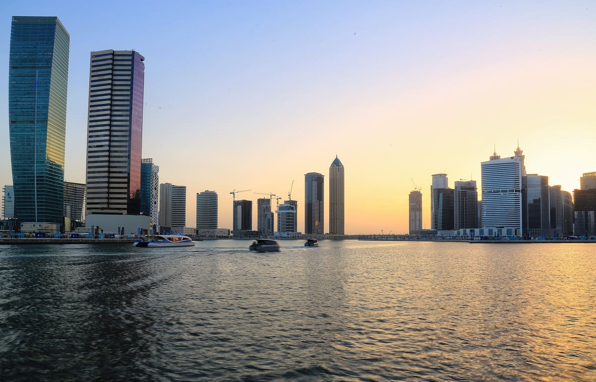 Business Bay towers over the water at sunset