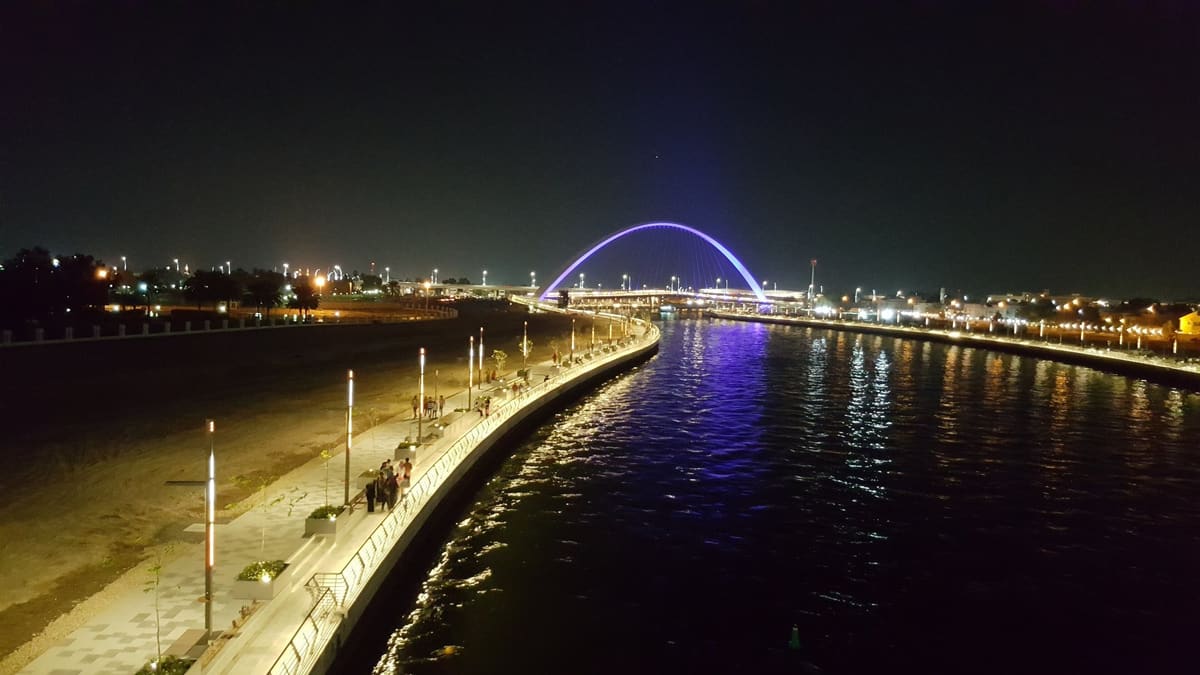 The arched bridge over Dubai Water Canal at night